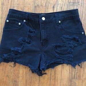 Black distressed Levi’s cutoffs
